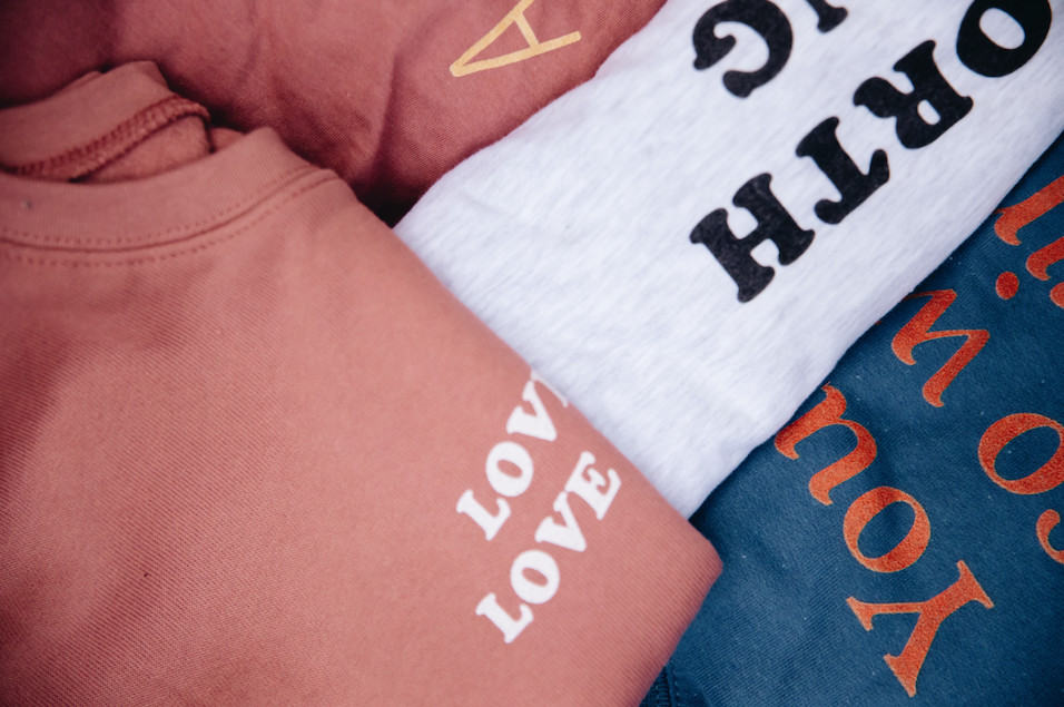 Shirts from So Worth Loving featuring empowering messages.