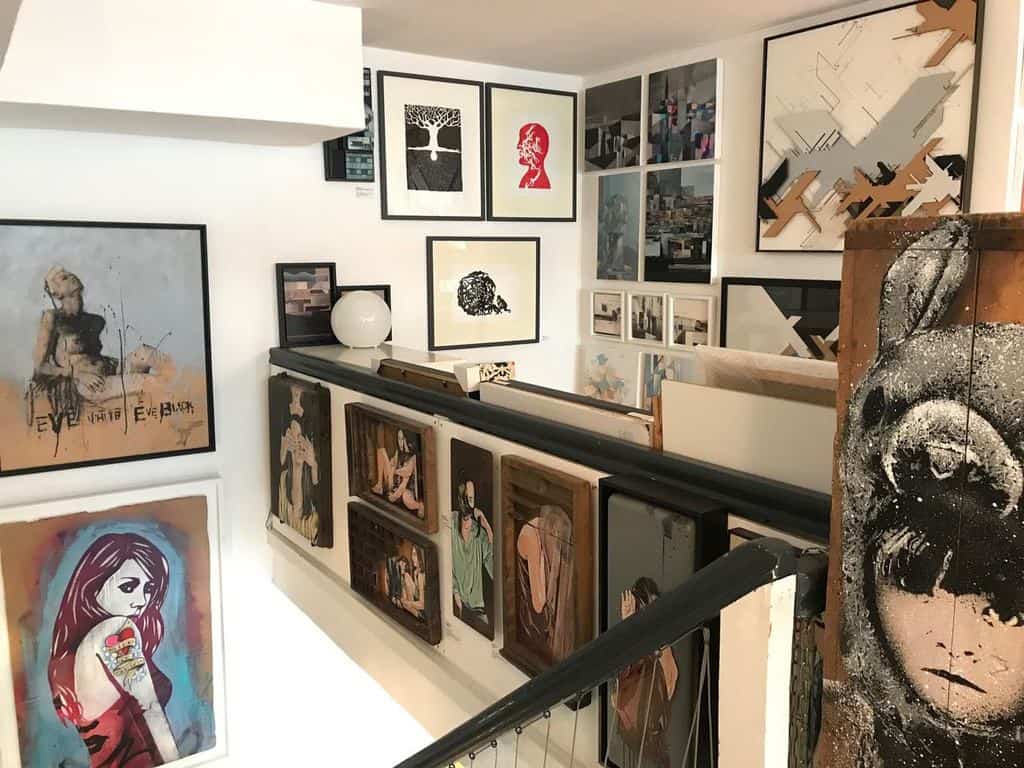 A collection of paintings being displayed within the Pretty Portal gallery in Düsseldorf.