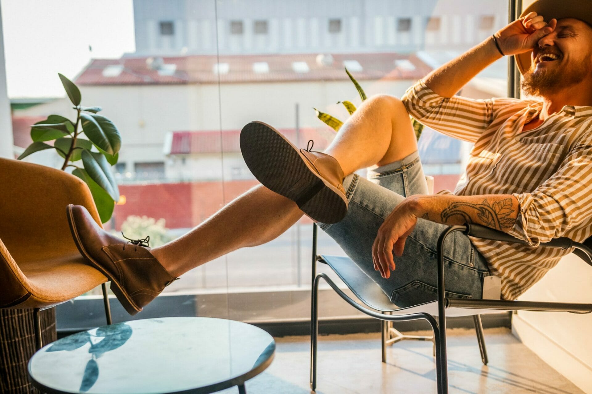 A male model wears a pair of Veldskoen Shoes in an office setting.