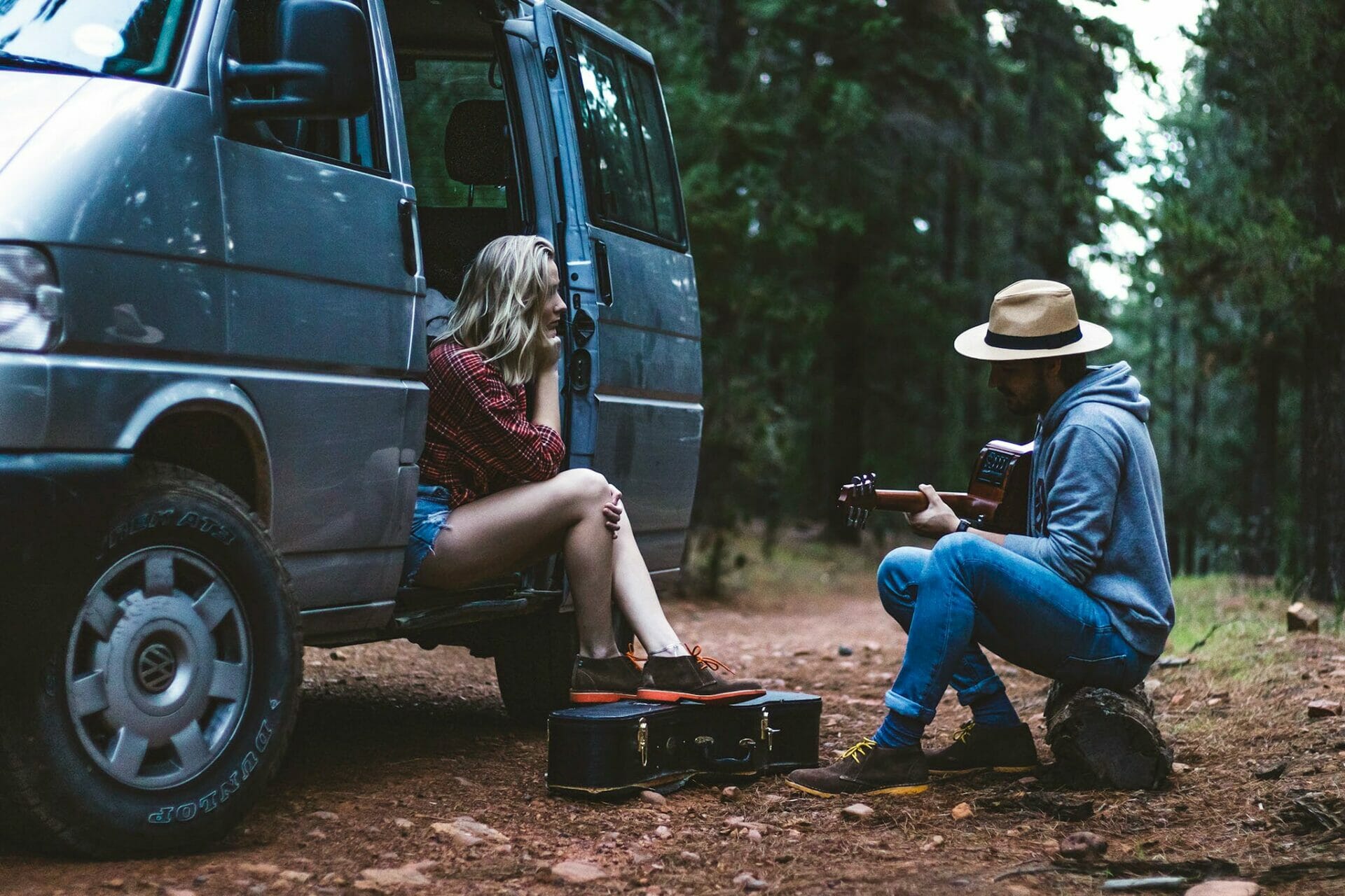 A set of models in a camping setting wearing Veldskoen Shoes.