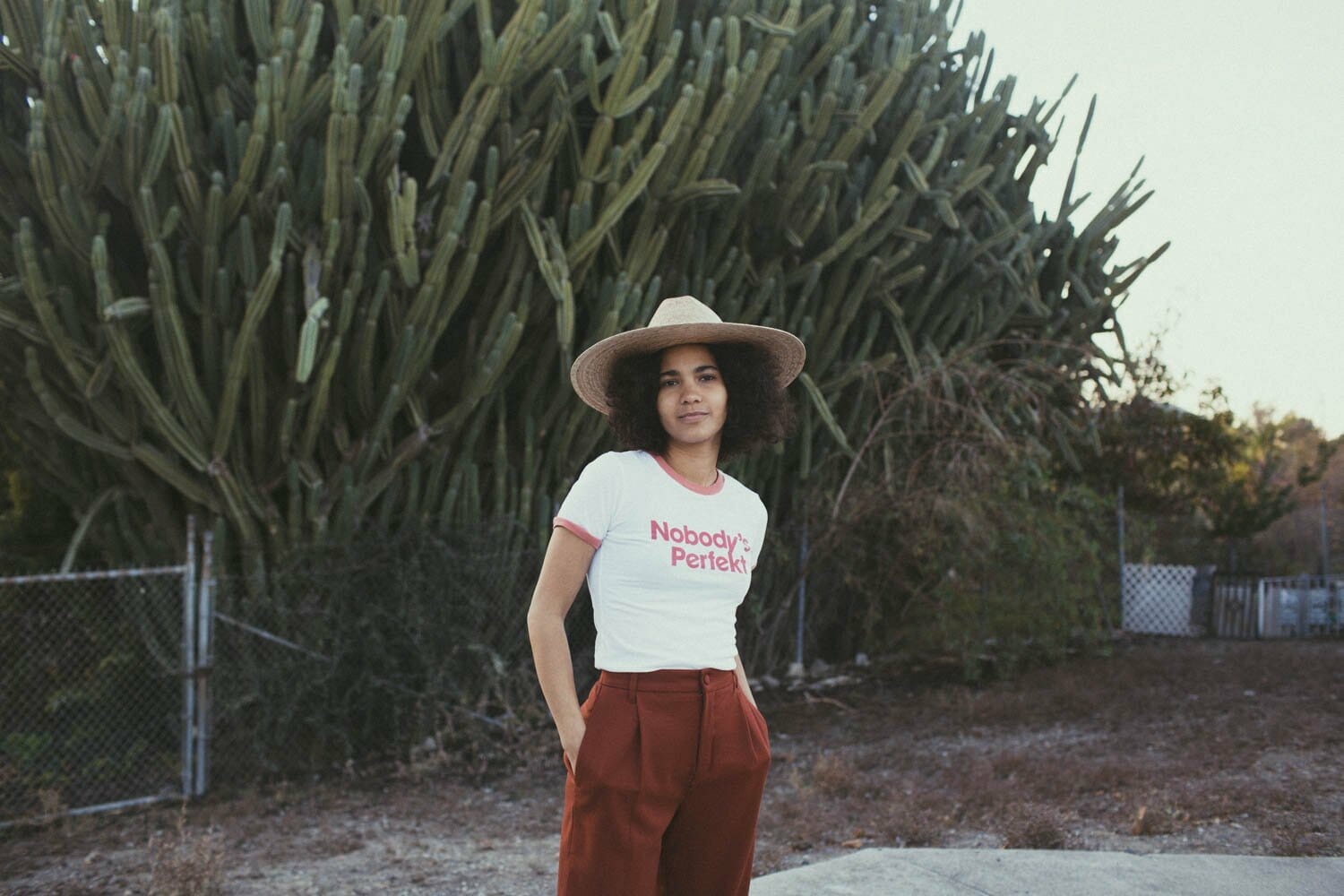 Woman in a hat and t-shirt that says