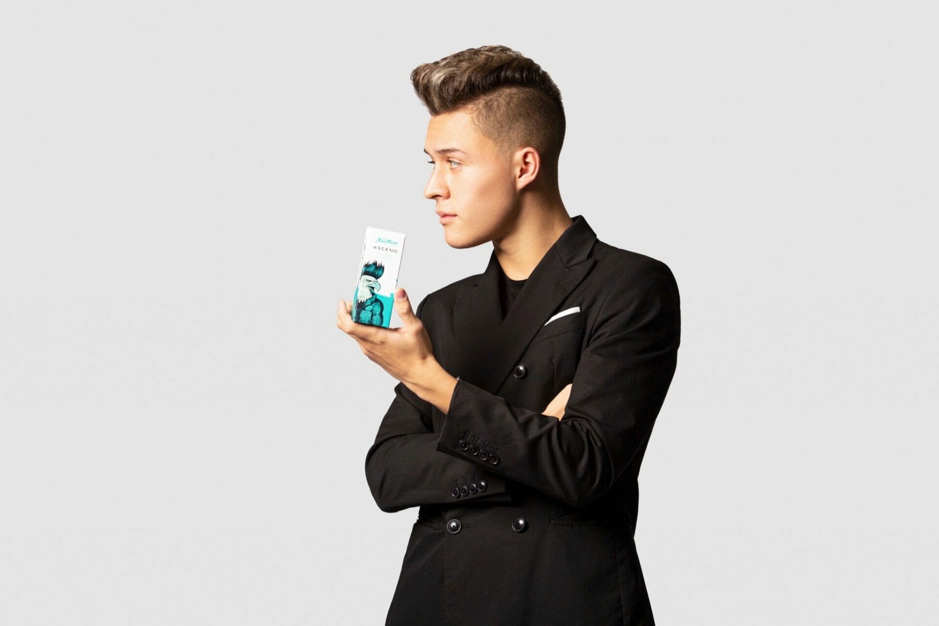 A model holds a hair cream created by BluMaan.
