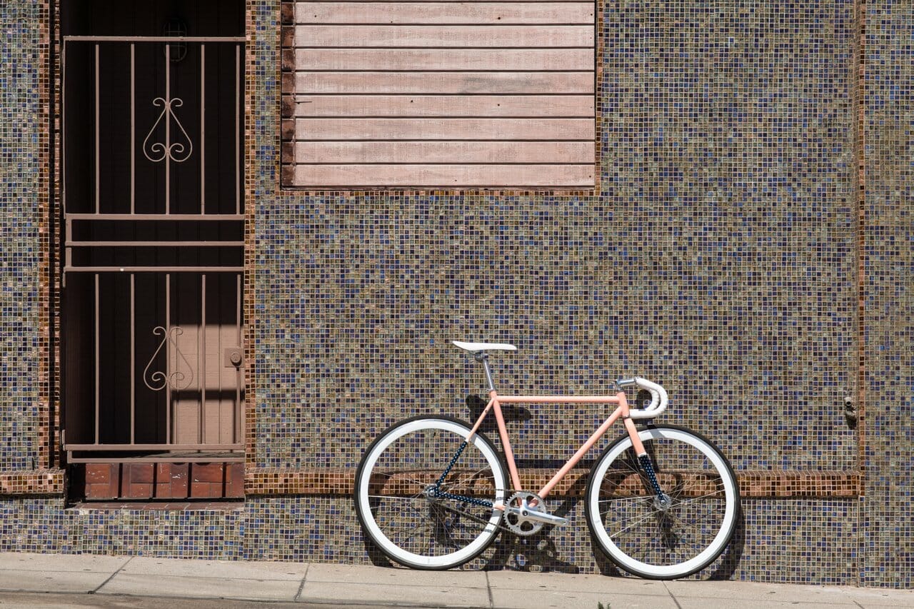 A bike against a concrete wall from State Bicycle Co.
