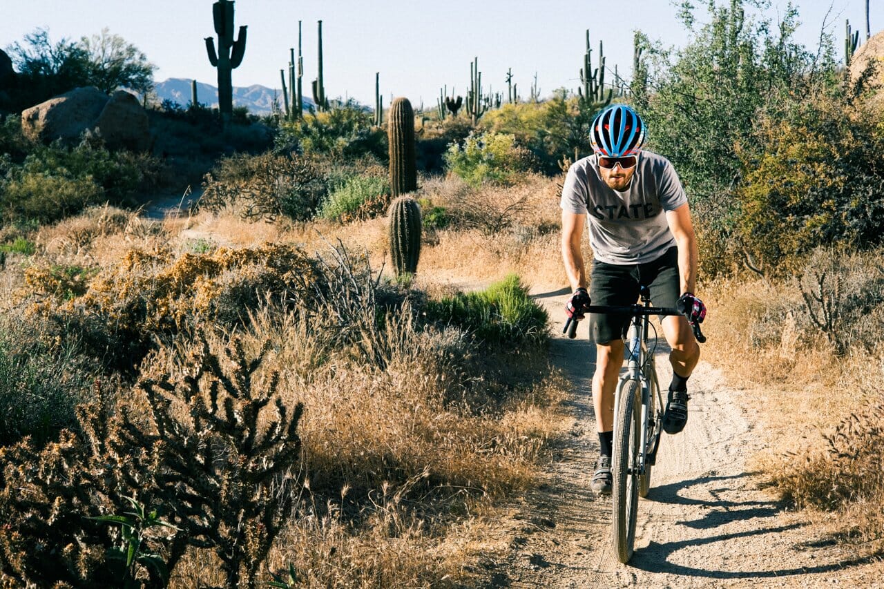 A bike rider in the dessert.