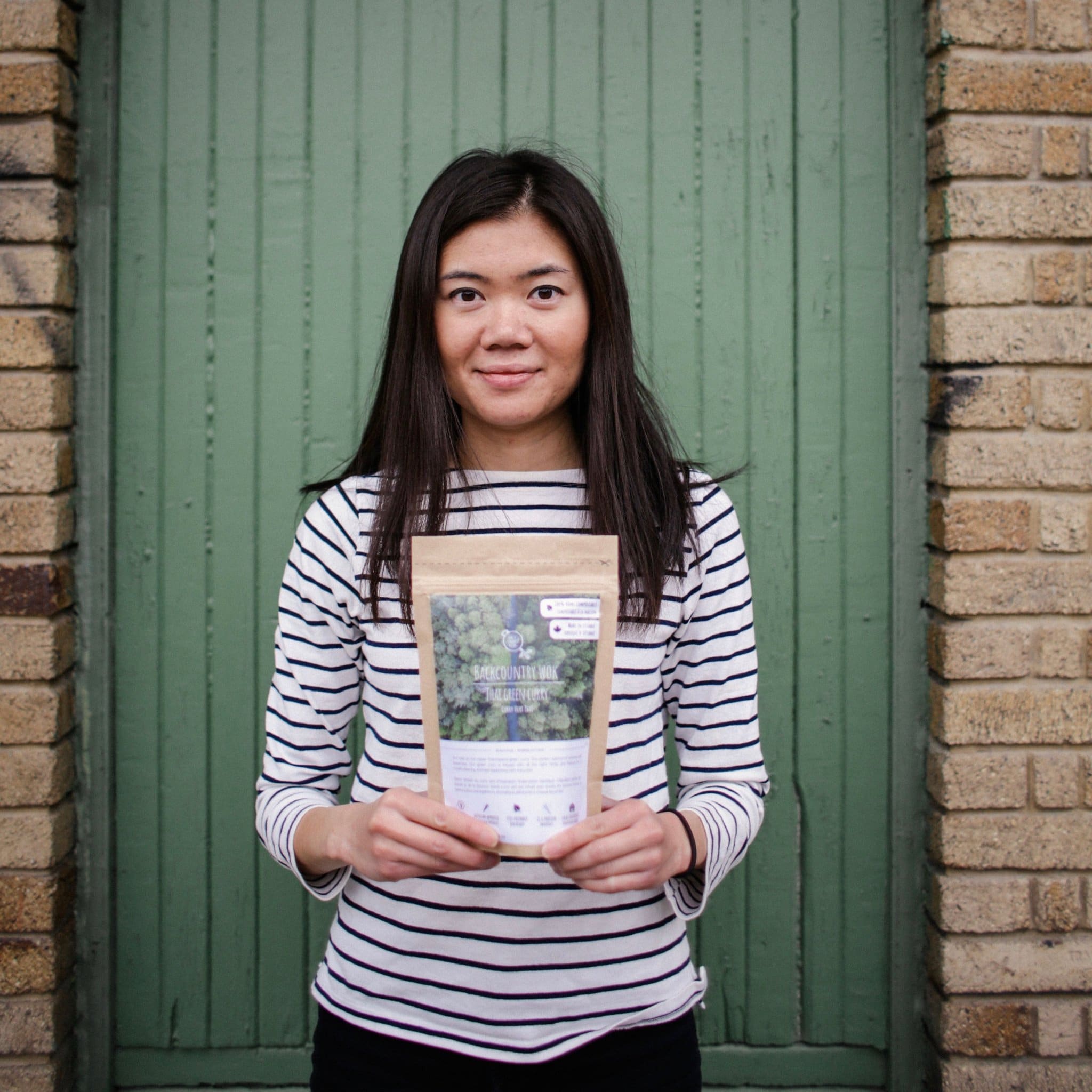 Melanie Ang, founder of Backcountry Work holding one of her products. 