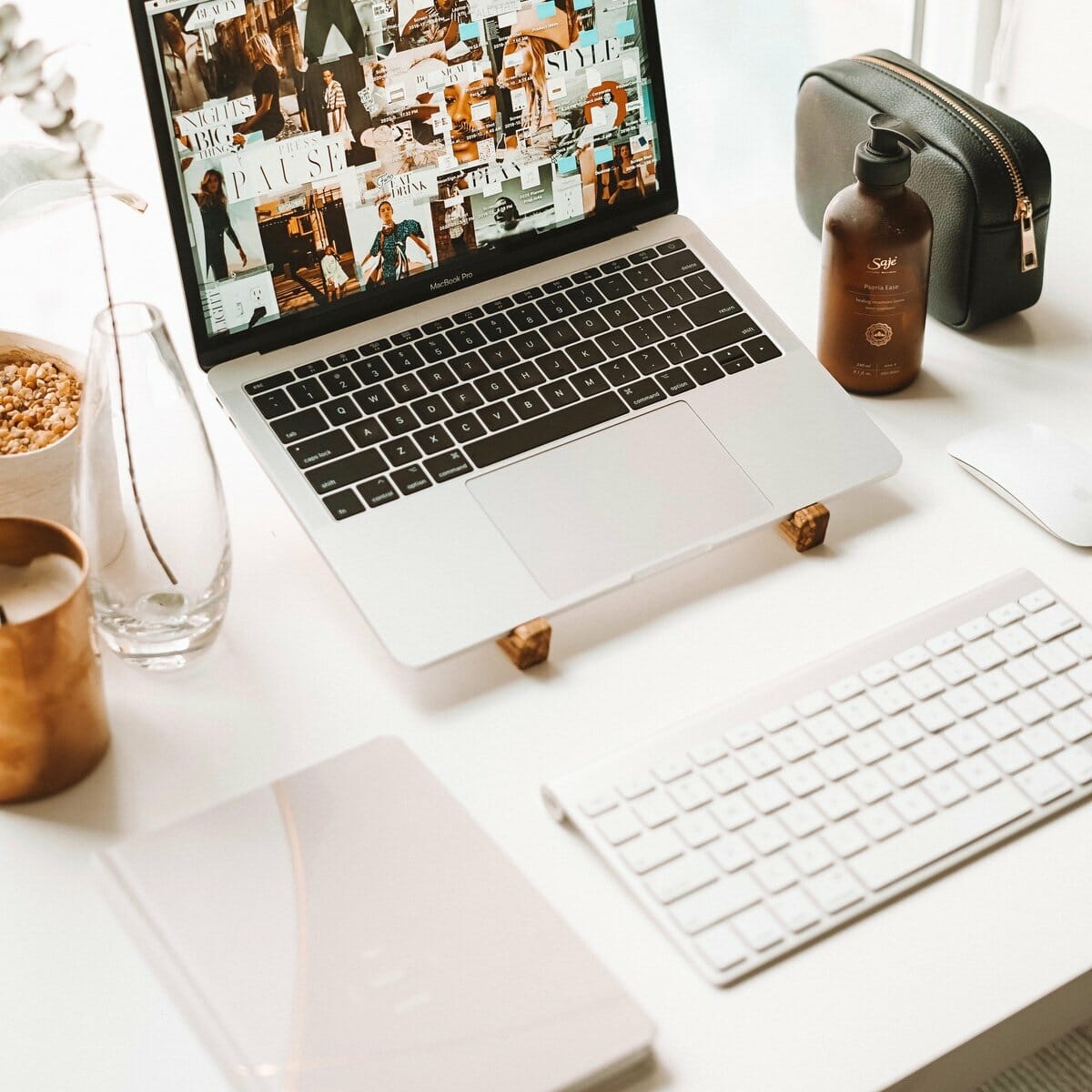 A blush coloured STIL planner next to a workstation setup. 