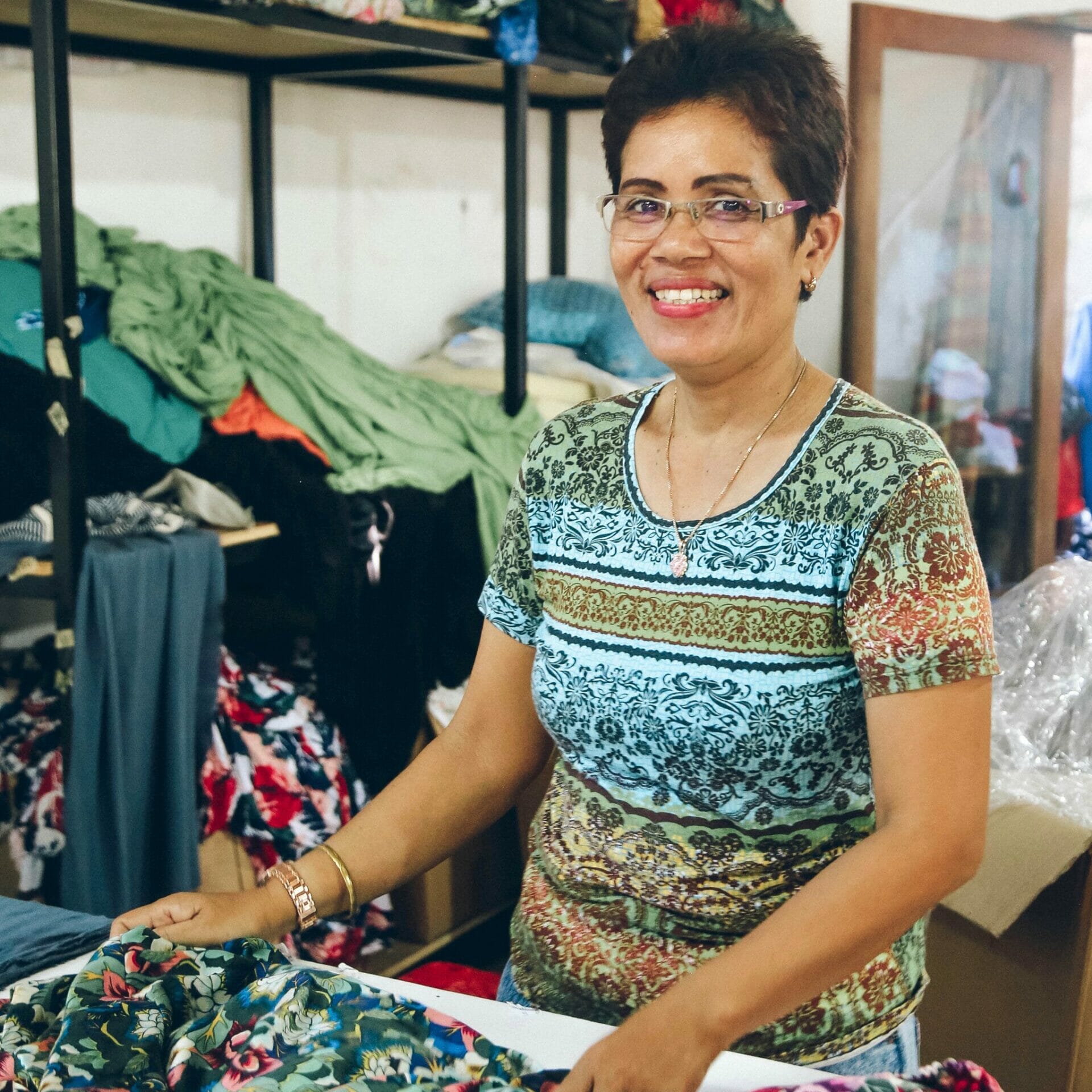 A garment worker in a production facility of TAMGA Designs.