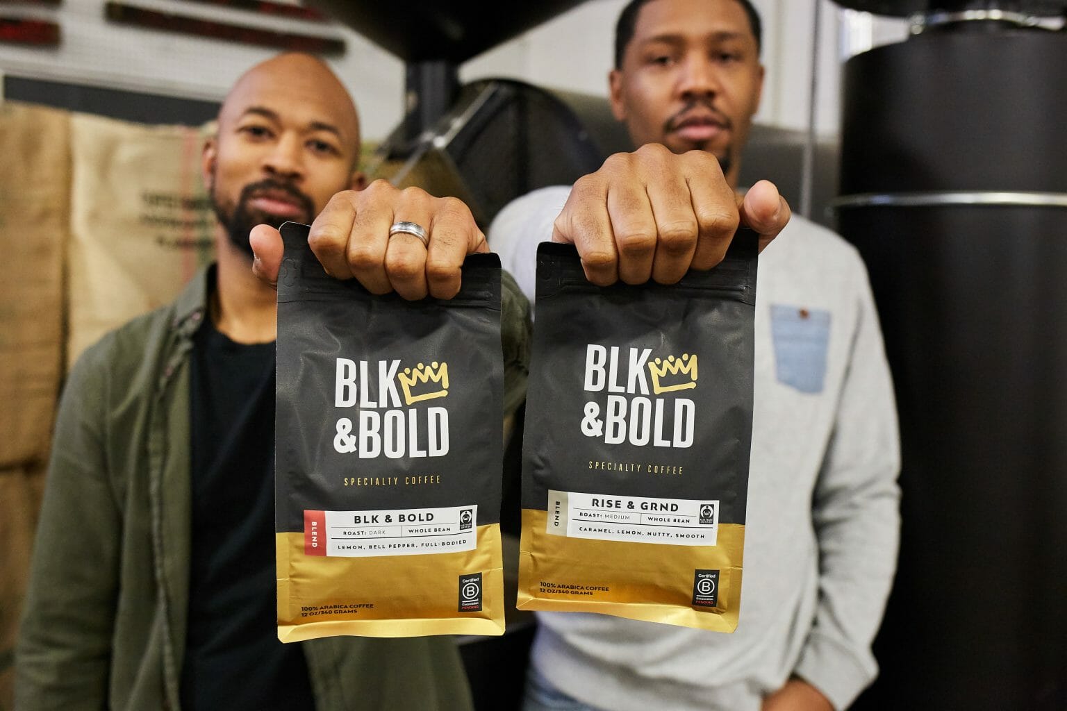 Pernell Cezar (left) and Rod Johnson (right) holding up bags of coffee from their brand, BLK & Bold.