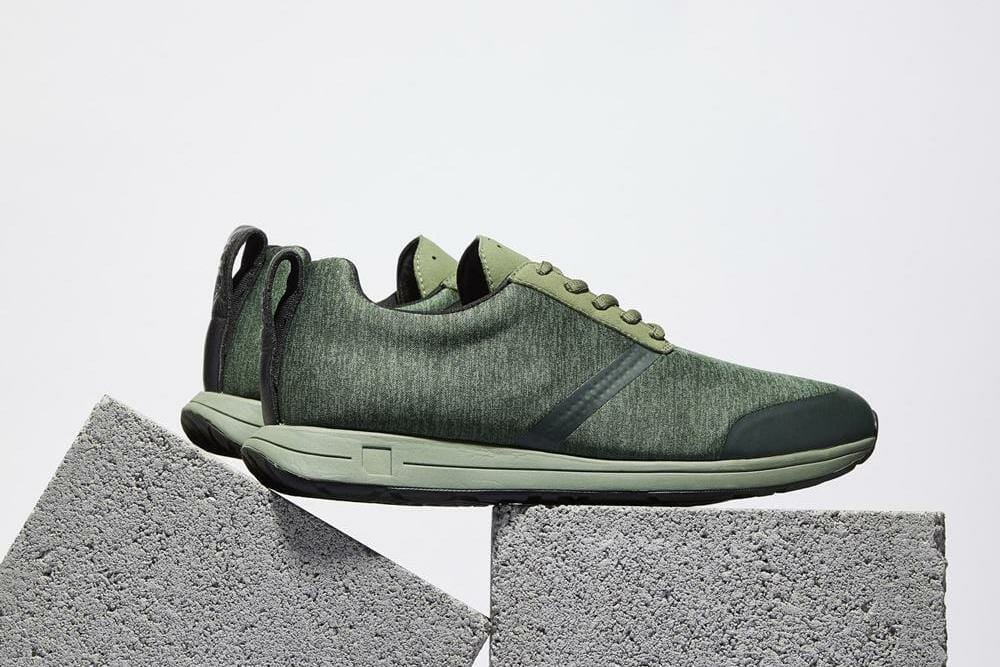 Green sneakers perched atop cinderblocks