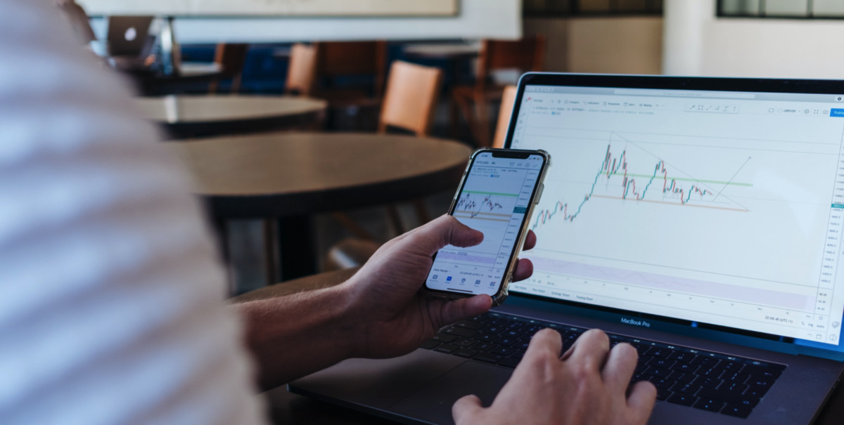 A person using a laptop to analyze ecommerce sales data on Shopify.