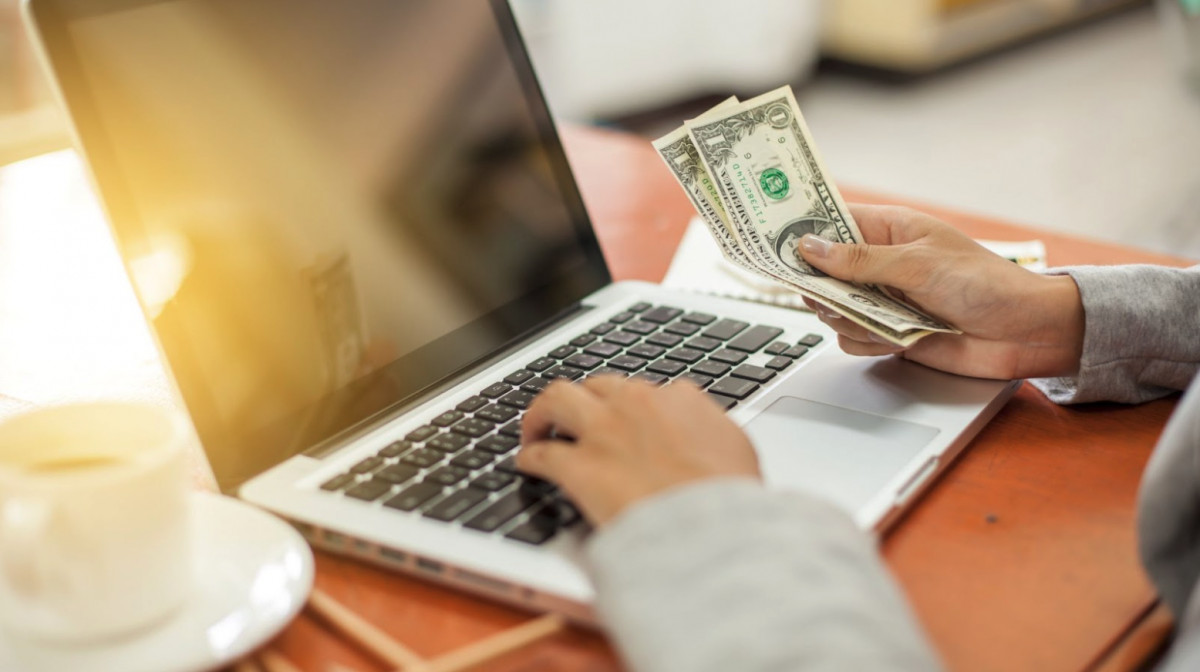 A man is using a laptop for ecommerce.