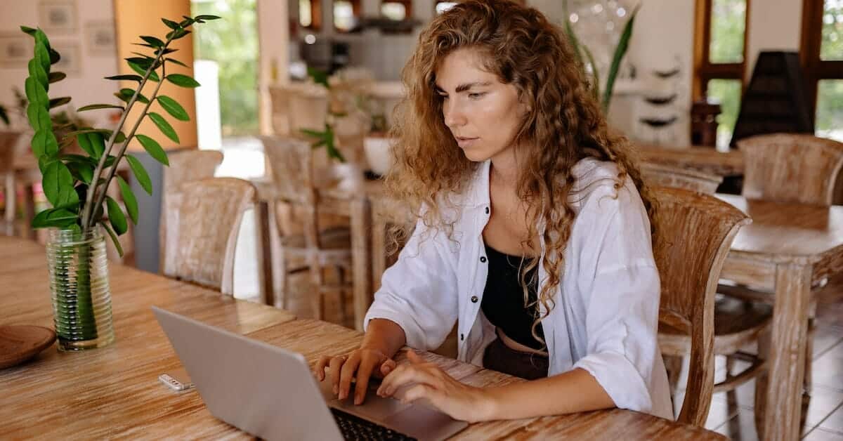 A woman utilizing Shopify on her laptop for ecommerce purposes.