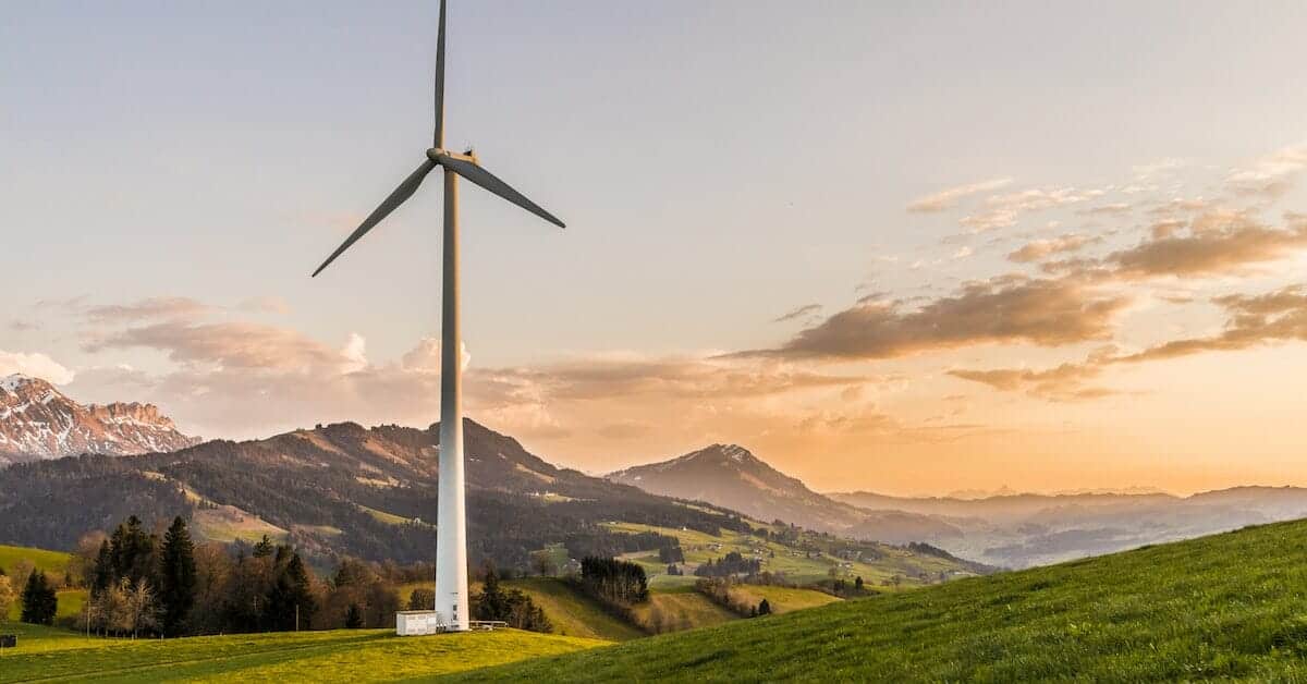 An eCommerce wind turbine in the mountains at sunset.