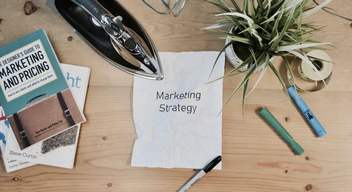 A piece of paper with the words "marketing strategy" written on it.