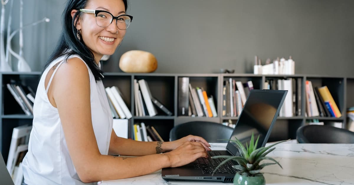 A businesswoman sitting at a desk with a laptop.
