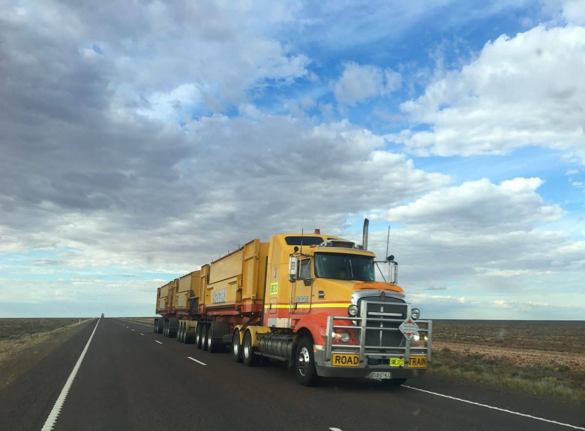 A commercial truck driving down a highway.