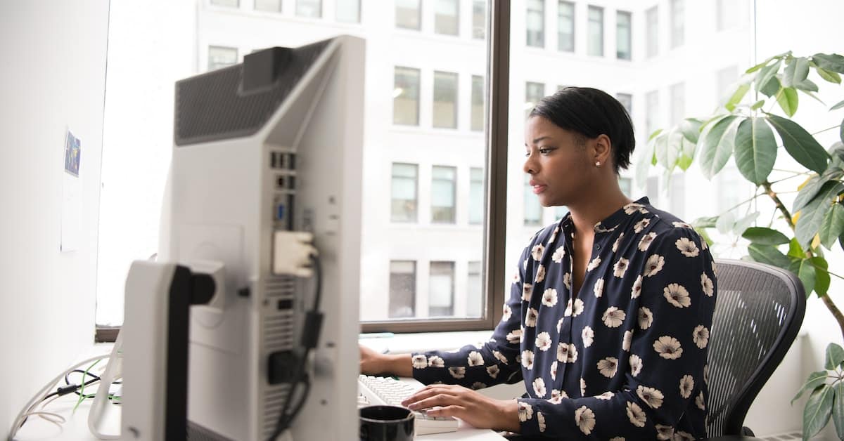 A woman innovating on a computer in an office.