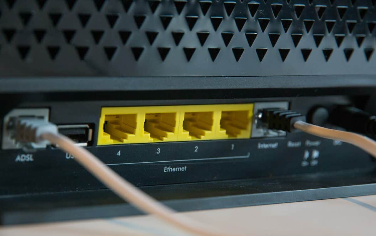 A close up of an ethernet cable connected to a router.