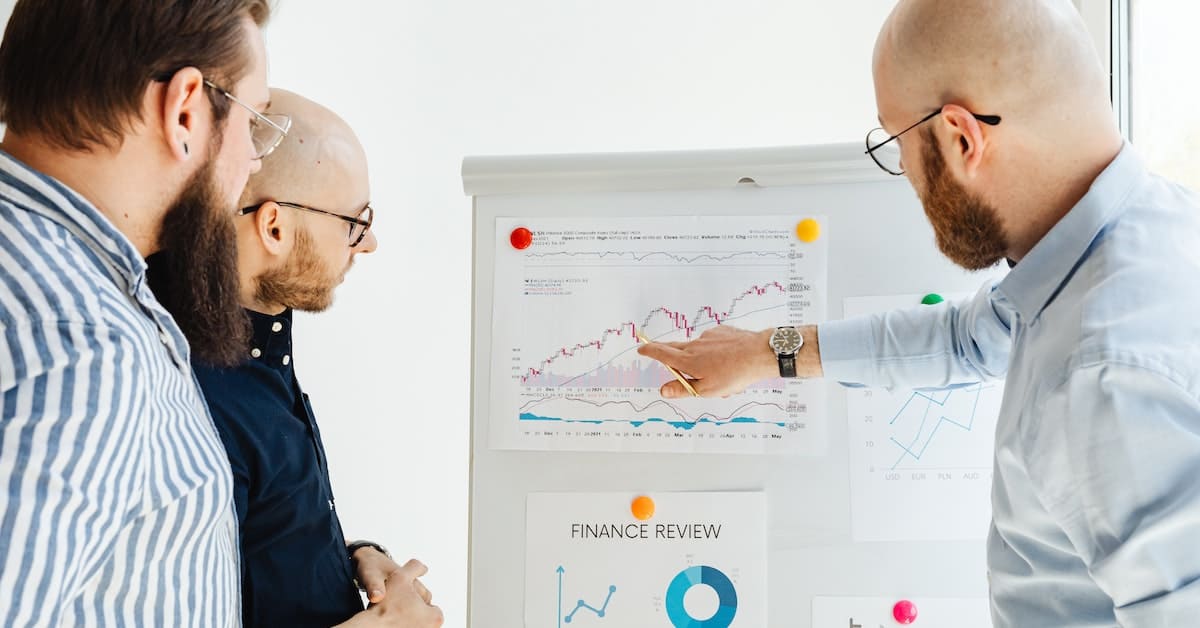 A group of business people analyzing growth graphs for scaling a Shopify store.