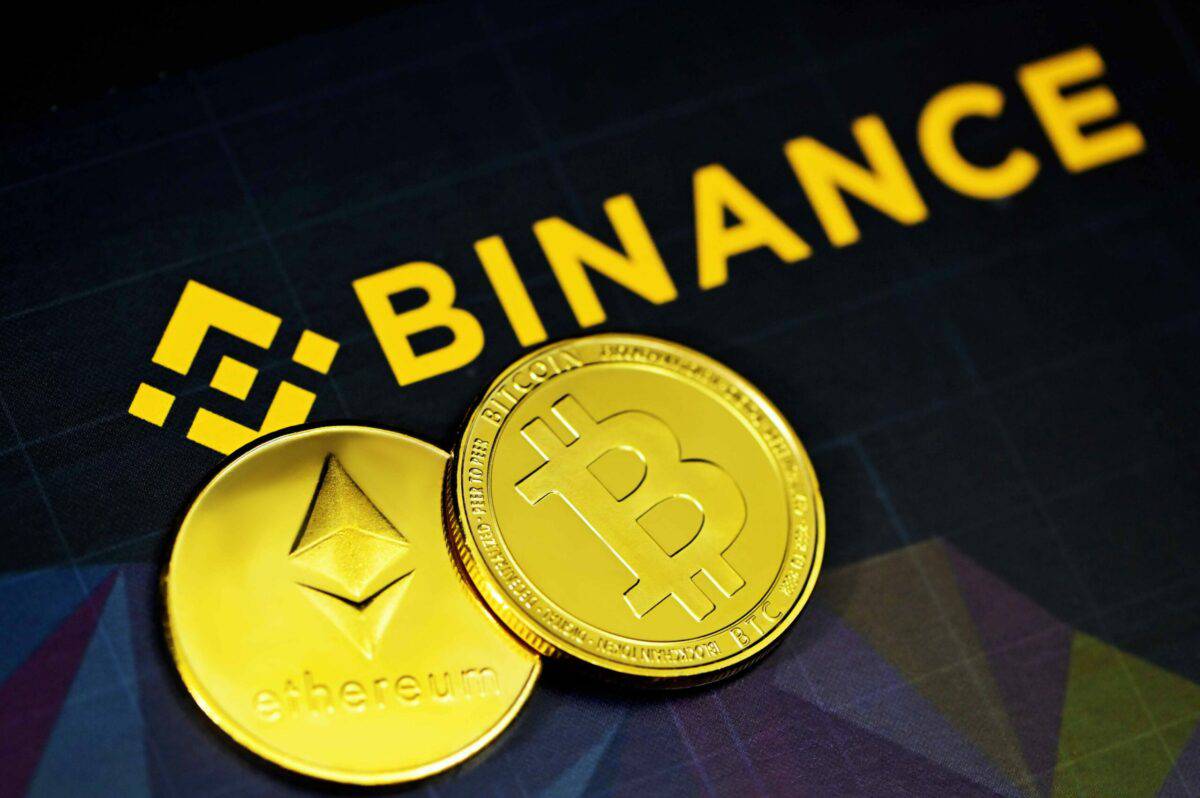 Physical coins of bitcoin and ethereum on a Binance-branded surface reflecting the Japan Revival in the cryptocurrency landscape.