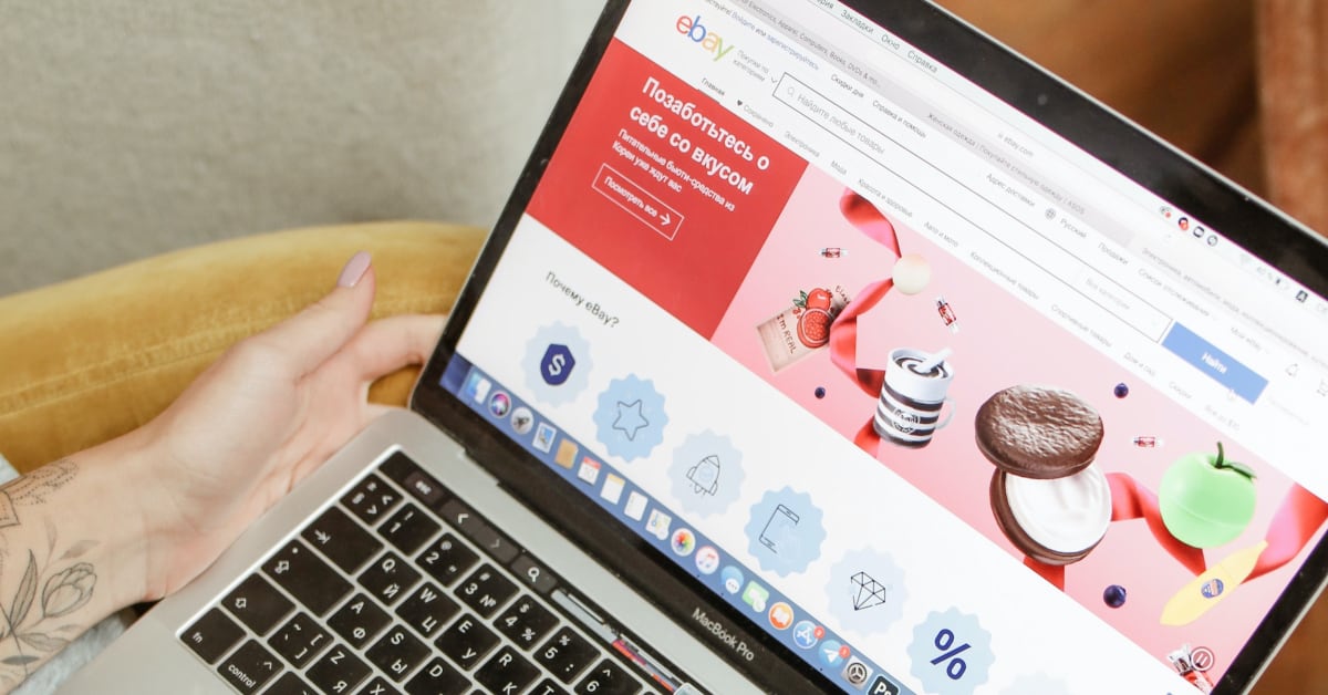 Person browsing eBay on a laptop, displaying the homepage highlighting various product images and influencer collaboration deals.