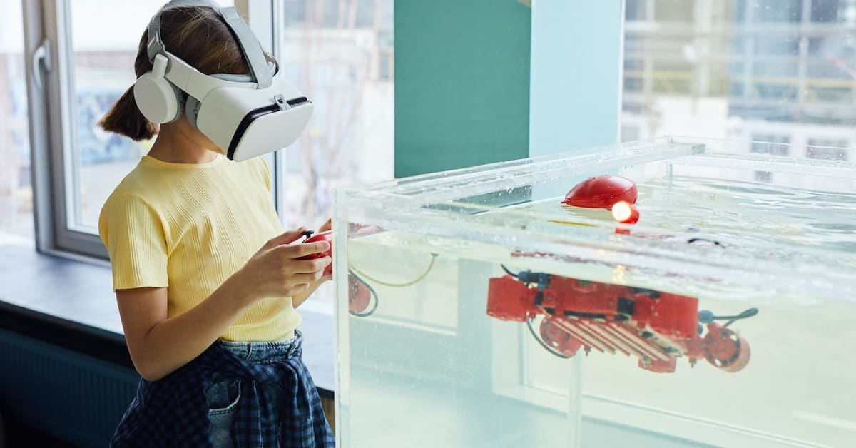 A woman using an AR headset observes a robotic experiment with a submerged device in a transparent water tank.