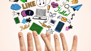 Fingers with smiley faces are raised, surrounded by various colorful doodles such as a laptop, paper plane, heart, and "Hello!" text bubbles—perfectly illustrating the lively spirit of social media.