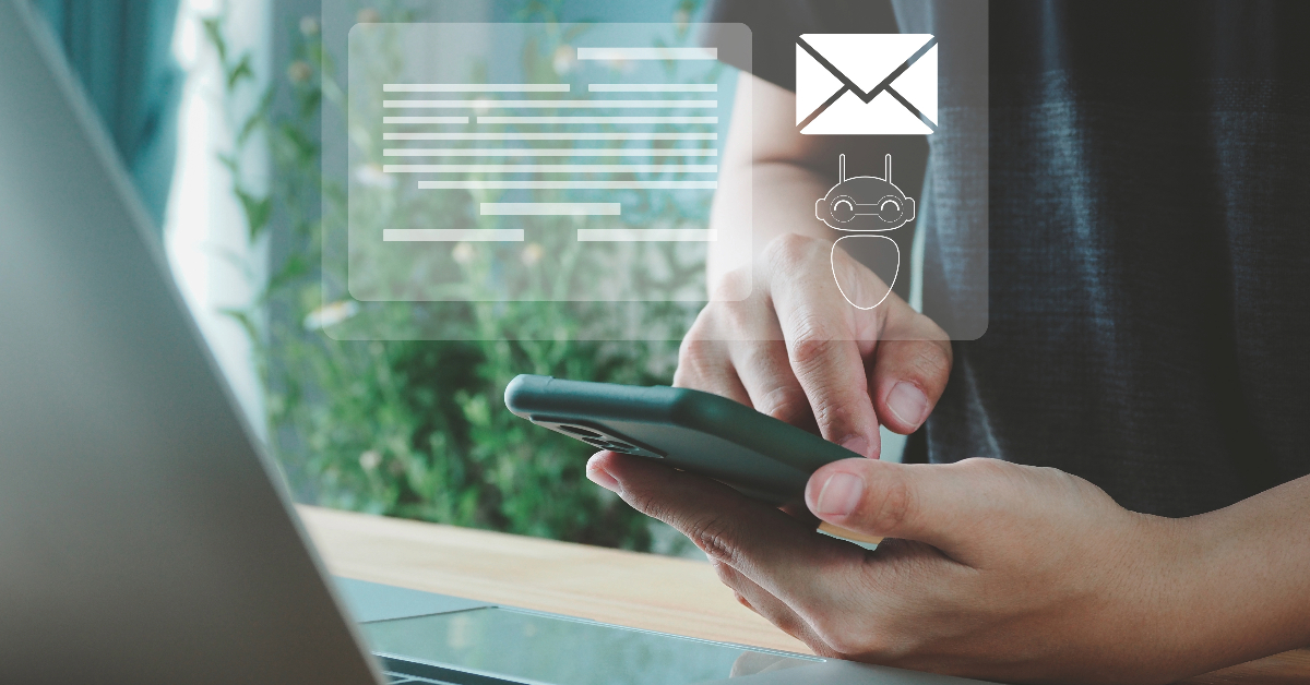A person types on a smartphone with floating icons of an email, a chat bubble, and a robot face in the foreground, hinting at sophisticated digital communication or email marketing automation.