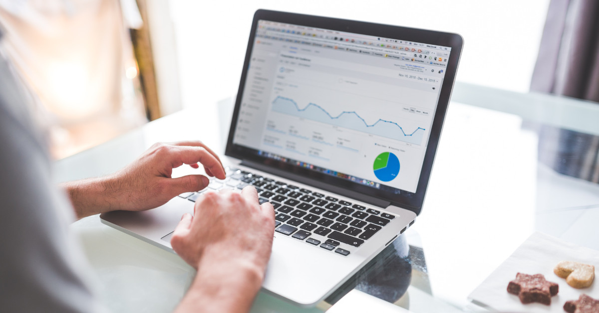 Person using a laptop displaying a data analytics dashboard with graphs and charts, analyzing ecommerce strategy to optimize Google Ads for eCommerce.