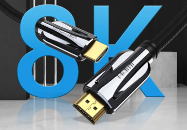 Close-up of two Active HDMI Cables with gold-plated connectors set against a blurred backdrop featuring a large blue "8K" text.