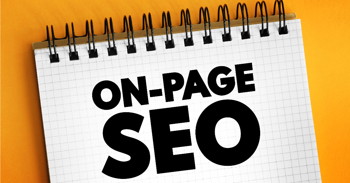 A spiral notebook with a checkered page features the text "On-Page SEO" in bold black letters against a yellow background, perfect for those delving into an SEO guide.