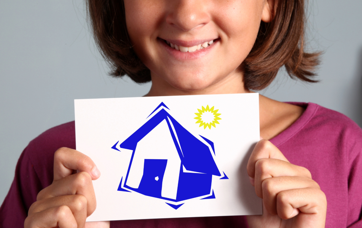 A child in a purple shirt holds a drawing of a blue house with a yellow sun in the upper right corner, offering a charming glimpse into the world of real estate through youthful eyes.