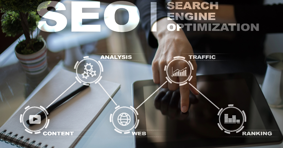 A person pointing at a tablet on a desk with graphics depicting SEO elements: content, analysis, web, traffic, and ranking. Text: "Improve SEO with Topic Clusters.