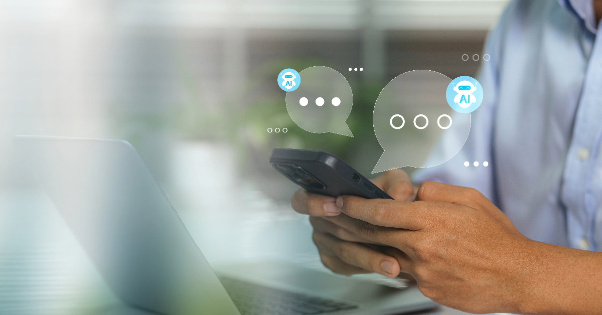 Person holding a smartphone with chat bubbles indicating a conversation with AI, discussing redesigning your site for better user engagement. A laptop is visible in the background.