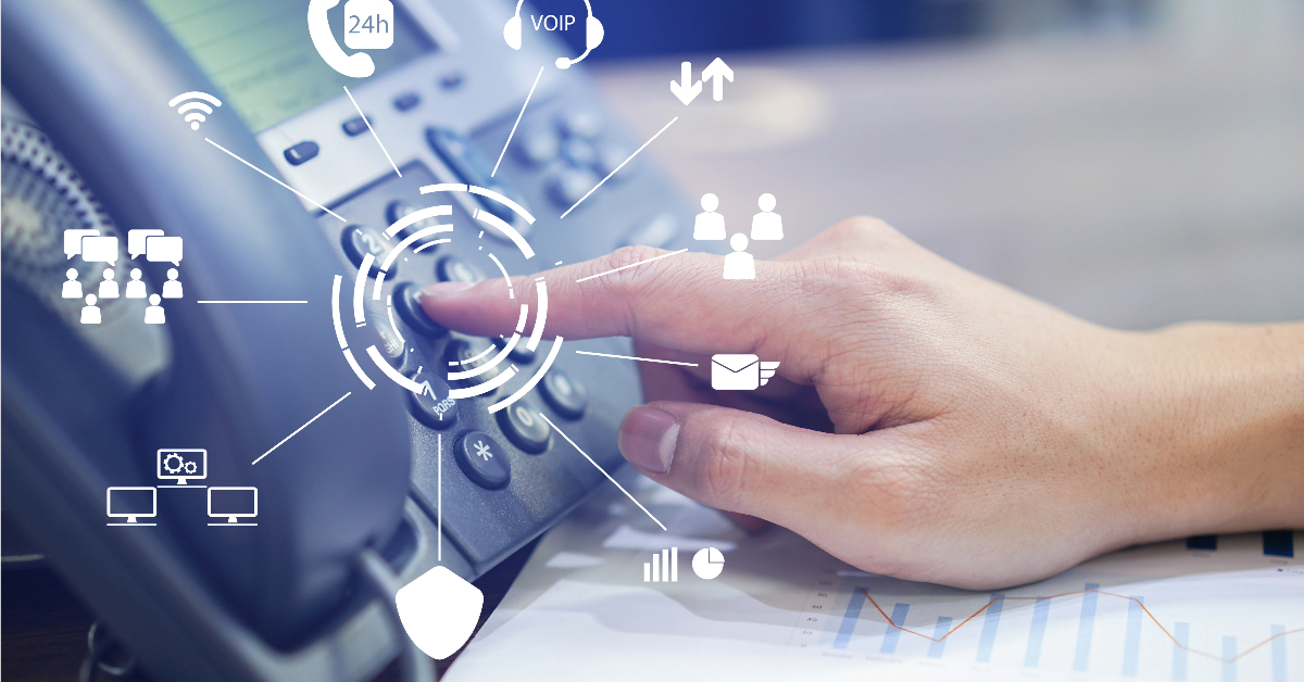 Person pressing a button on an office phone with icons representing various communication options such as VoIP, email, and customer support around it, highlighting potential cost savings in communication expenses.