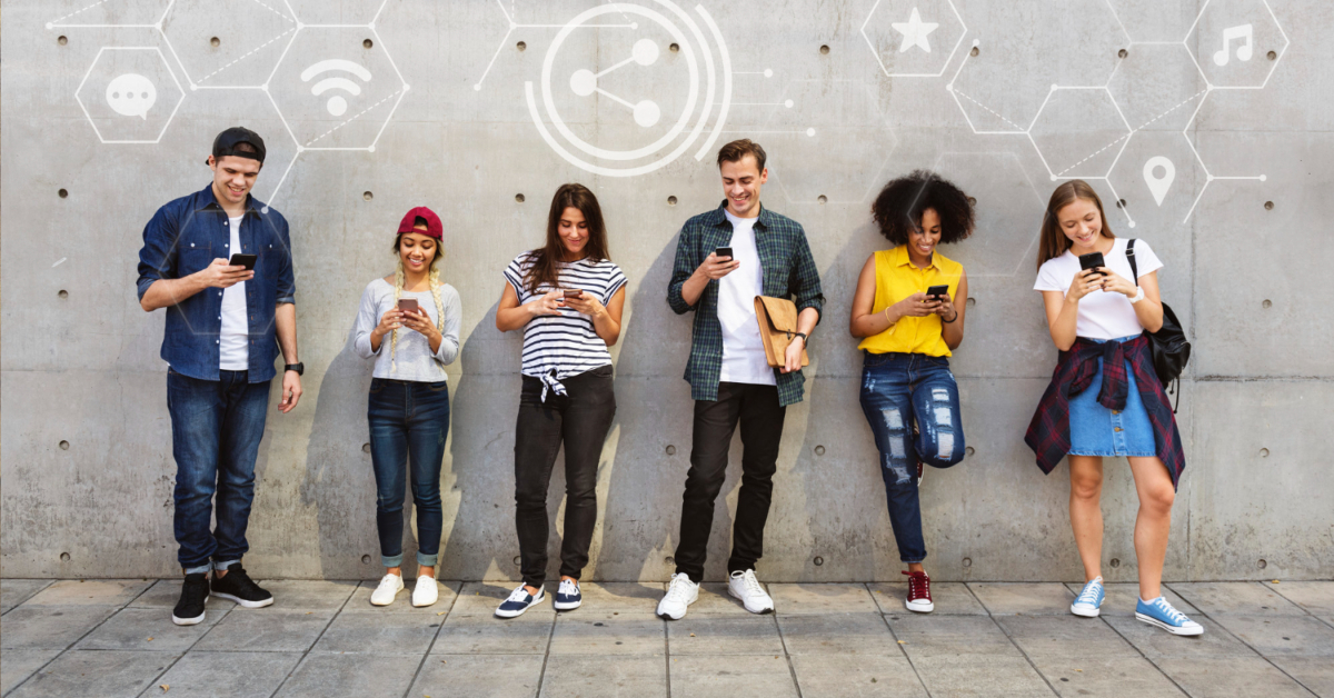 Six people stand against a concrete wall, each looking at their smartphones. Digital icons related to communication apps and social media float above their heads, illustrating the future of communication and seamless conversations.