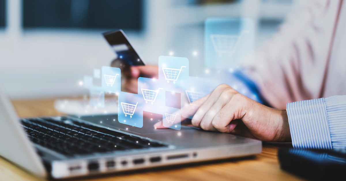 A person using a laptop and holding a credit card, with floating shopping cart icons representing B2B eCommerce and online shopping.