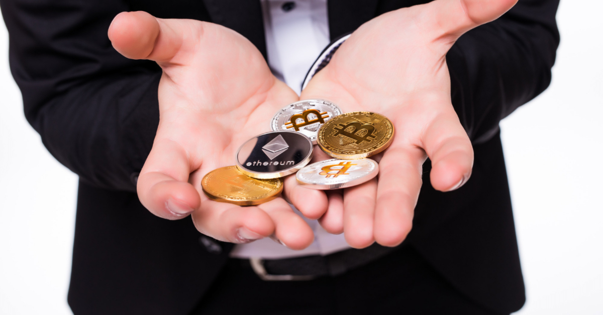 A person in a suit holds various cryptocurrency coins in their cupped hands, including Bitcoin and Ethereum, pondering over the ERC20 standard.