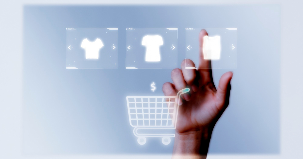 A hand is selecting a clothing item from three options displayed on a digital interface with a shopping cart icon below, showcasing the seamless user experience enabled by advanced ecommerce development.