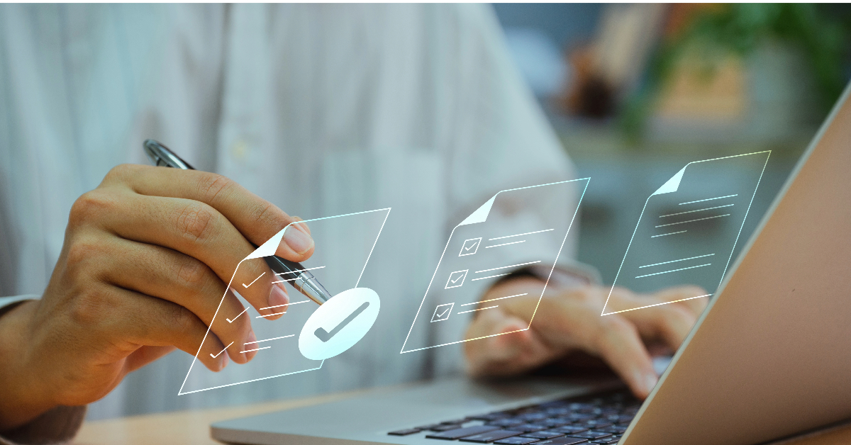 A person is using a laptop. Their right hand holds a pen and hovers over a holographic interface displaying documents and check marks, harnessing the power of screen recording to assist QA teams in their tasks.