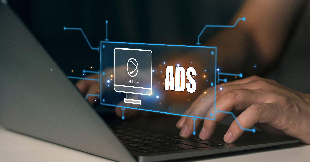 Close-up of hands typing on a laptop with a digital graphic overlay depicting a computer screen displaying a play button and the words "Google Ads" intertwined with Performance Max Campaign elements.