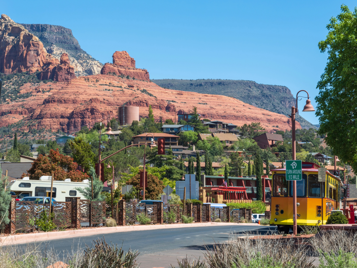 A yellow trolley is on the street, offering residents an adventurous ride through hidden gems in Arizona.