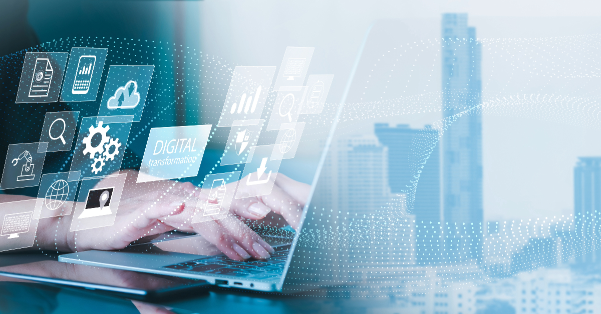 Person typing on a laptop with digital transformation icons overlaying the image, highlighting AI-Driven Decision Making, against a background of city buildings.