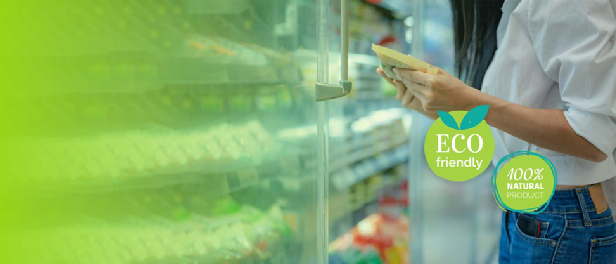 A woman is standing in front of a green refrigerator, symbolizing the sustainable supermarket revolution. | renewable energy