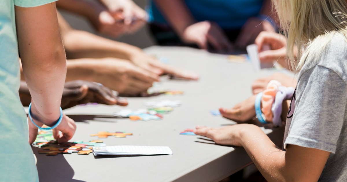 A family-friendly group coming together to make and solve jigsaw puzzles.