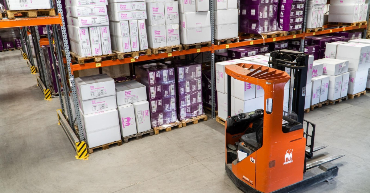 A NetSuite forklift truck in a warehouse full of boxes for online retailers.