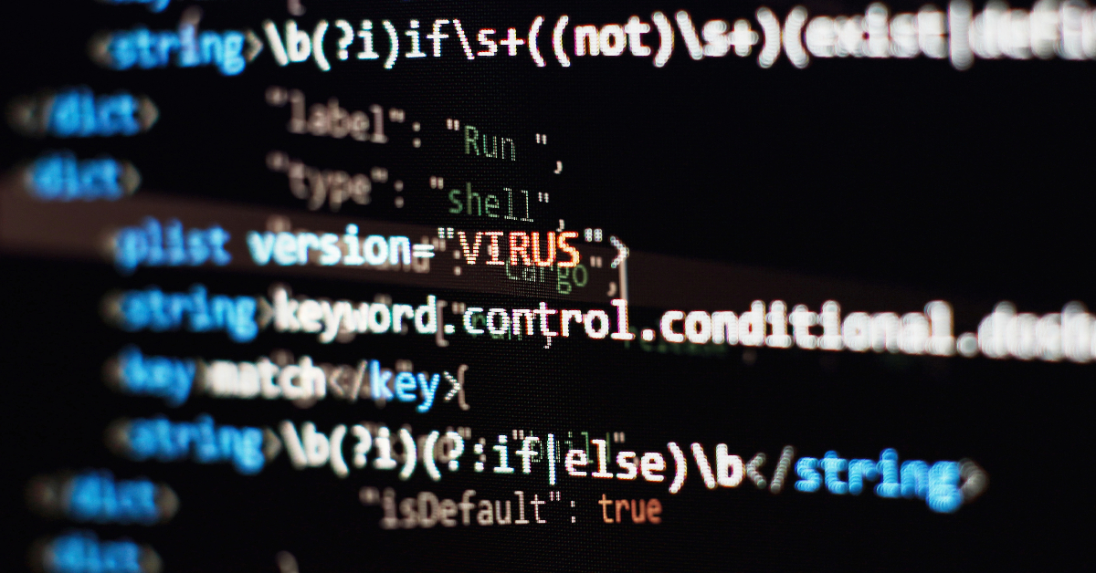 Close-up view of computer code displayed on a screen with the word "VIRUS" highlighted in red text, emphasizing the importance of cybersecurity.