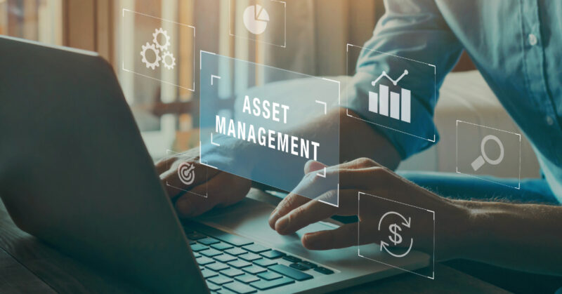 A person working on a laptop with icons representing asset management, gears, charts, and search tools floating around the screen highlights how digital asset management can enhance creativity and streamline workflow management.