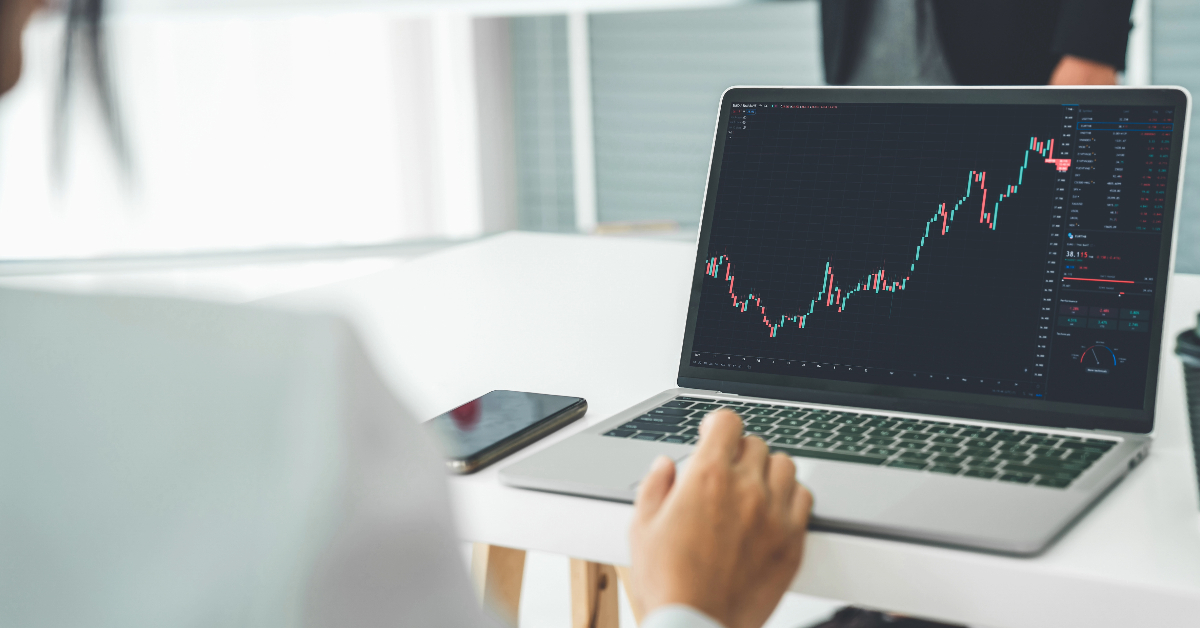 A woman is using a laptop to solve issues related to forex brokerages.