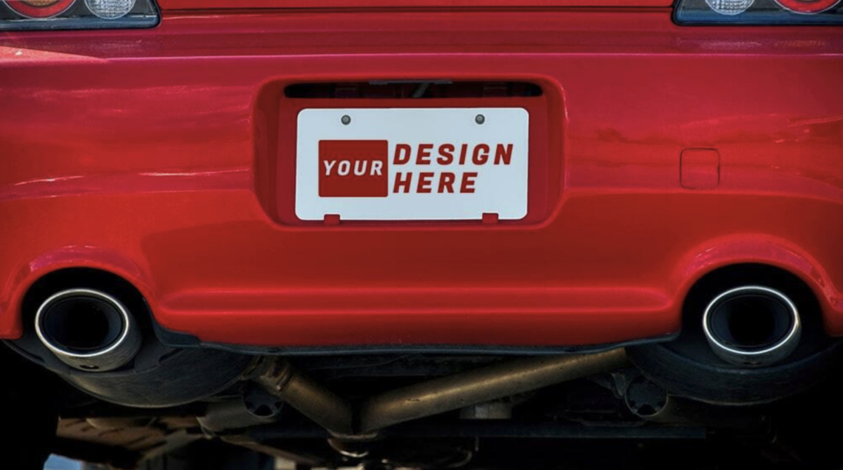 A powerful red Nissan sports car with a custom license plate, driving with brand success.